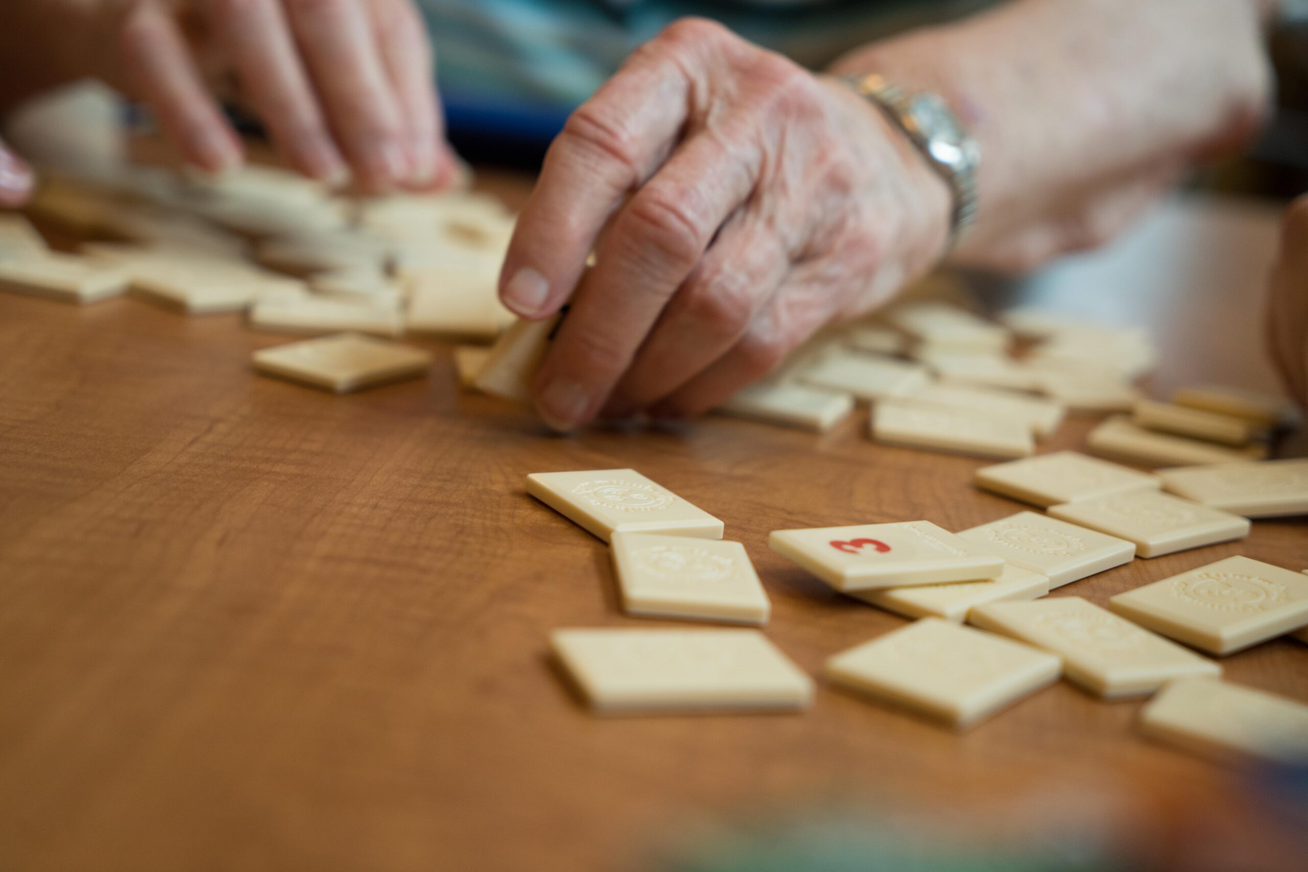 elderly hands playing a table game